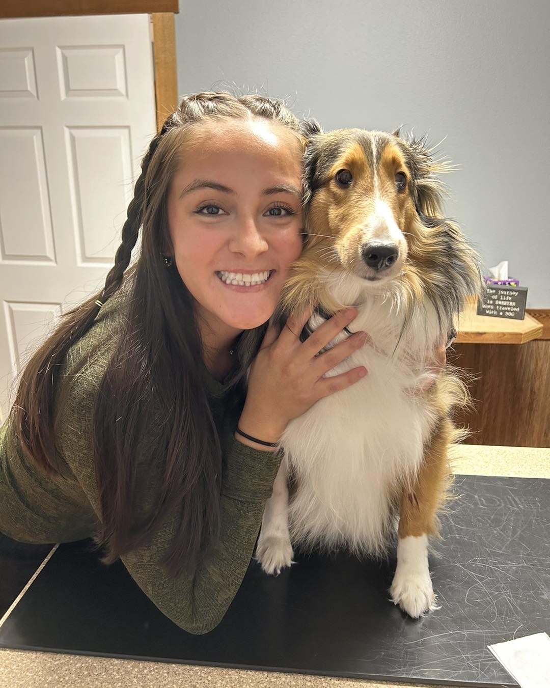 Lucy smiling with her sheltie dog