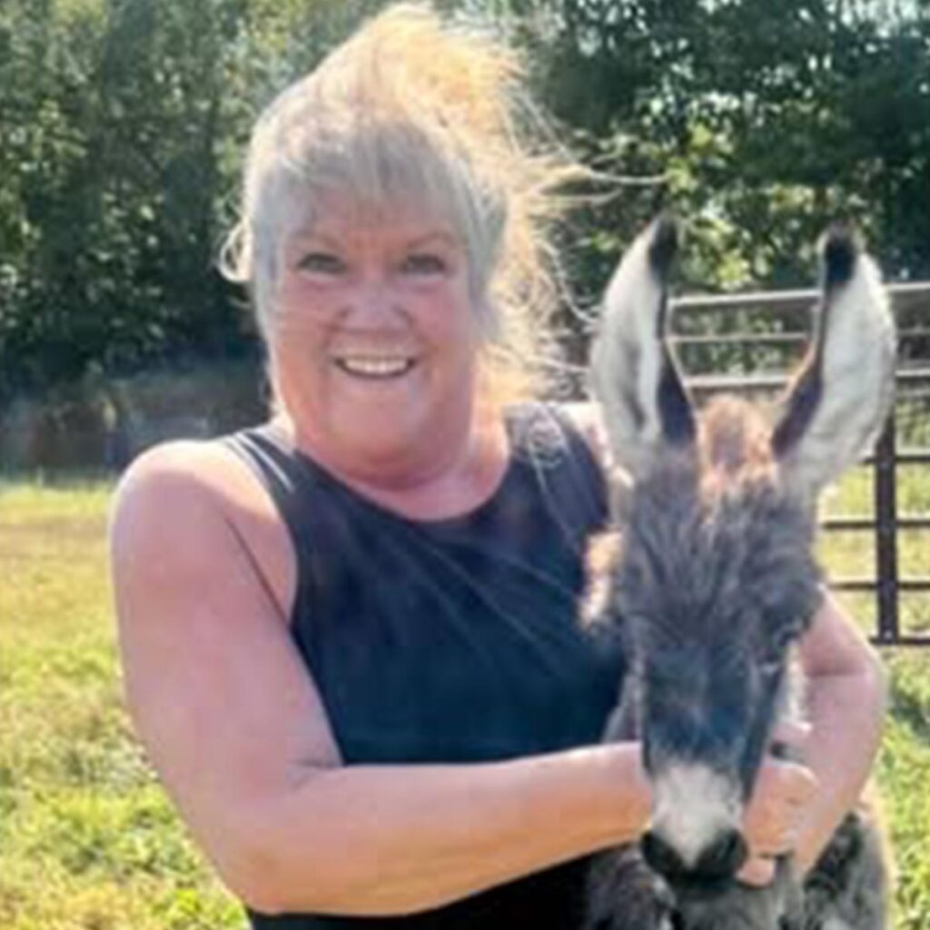 Claudia hugging a donkey
