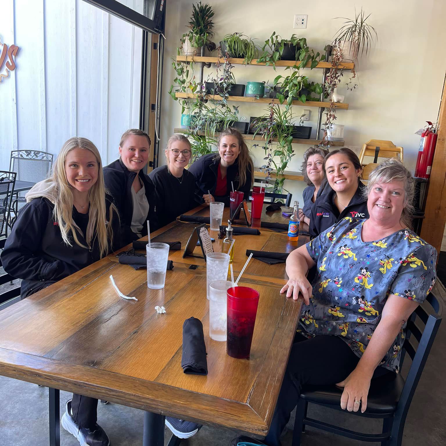 Jackson veterinary team members sitting together at a table at a restaurant